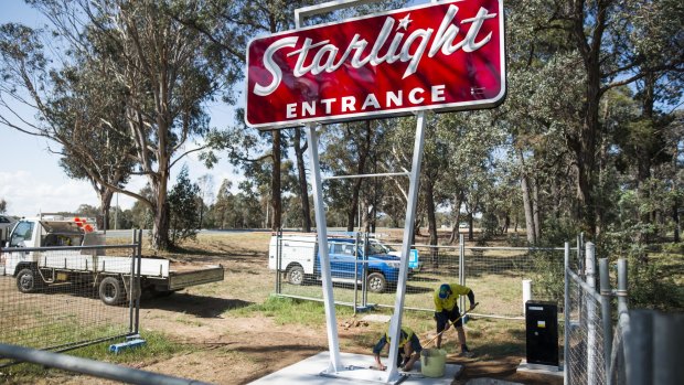 Workers put the final touches on the restored Starlight drive-in sign on Monday.