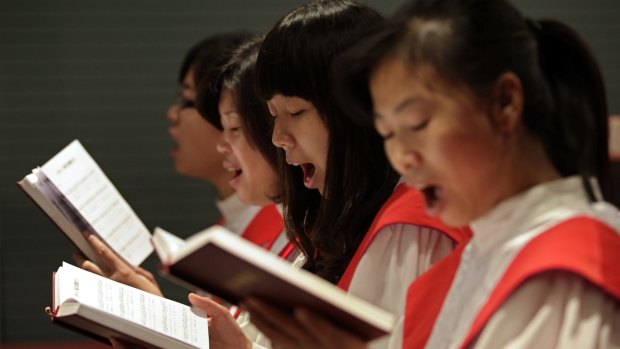Members of Shouwang Church's choir sing hymns during Sunday service in Beijing. Shouwang is a "house church", not officially sanctioned by the government .