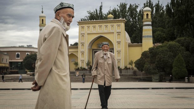 Unrest: Uighur men in front of the Id Kah Mosque, China's largest mosque, in Kashgar, Xinjiang.