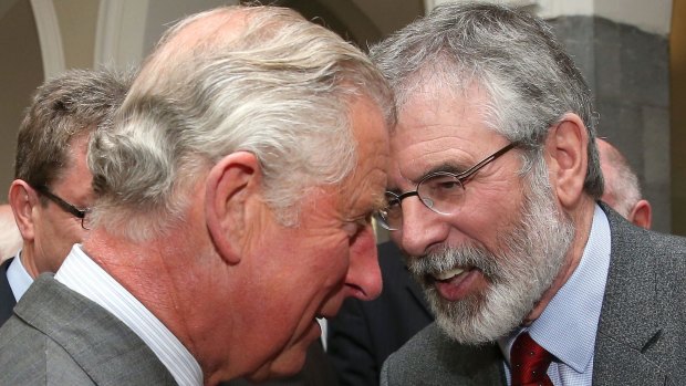 Smiles all round ... Britain's Prince Charles, Prince of Wales (L) speaks with Republican party Sinn Fein leader, Gerry Adams whilst they shake hands.