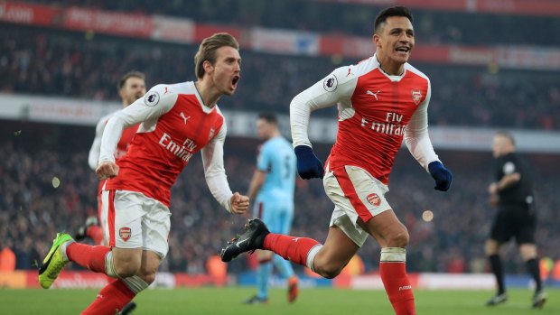 Late show: Alexis Sanchez celebrates his late winner from the penalty spot.