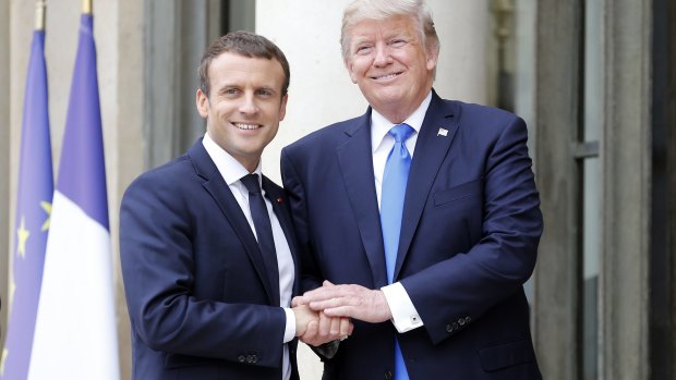 A different handshake:  French President Emmanuel Macron welcomes US President Donald Trump at the Elysee Presidential Palace on July 13.