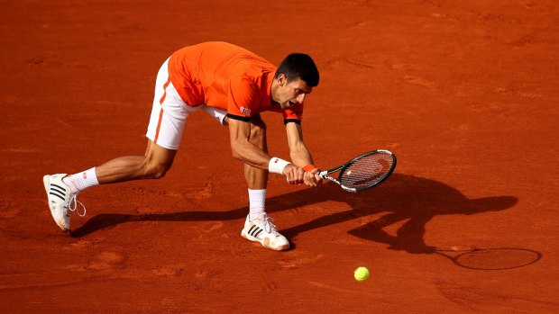 Novak Djokovic of Serbia plays a backhand during his second-round match against Gilles Muller of Luxembourg.