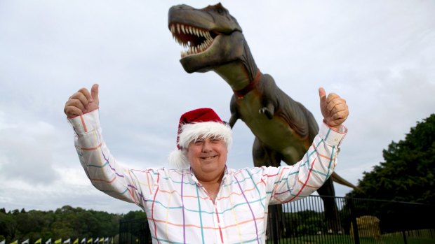 In happier times ... Clive Palmer with Jeff the dinosaur which was destroyed by fire..