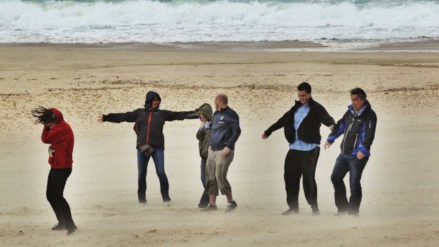 Tourists brave the weather at Bondi Beach.