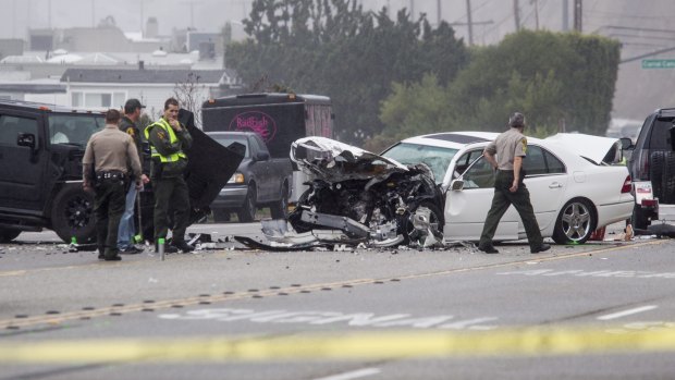 Los Angeles County Sheriff's deputies investigate the scene of a collision involving former Olympian Bruce Jenner.