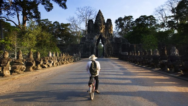 Cycling along the road towards South Gate of Angkor Thom.