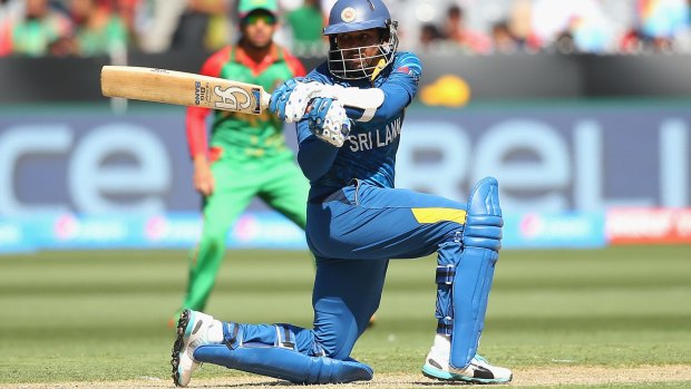 Tillakaratne Dilshan clubs a delivery against Bangladesh.