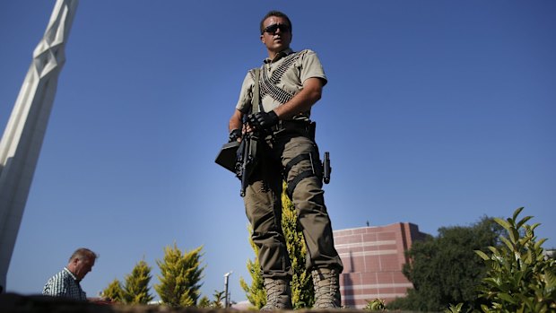 A Turkish police special forces officer provides security as Turkish President Erdogan attends the funeral of his campaign manager Erol Olcak and his son, killed on Friday while protesting the attempted coup.