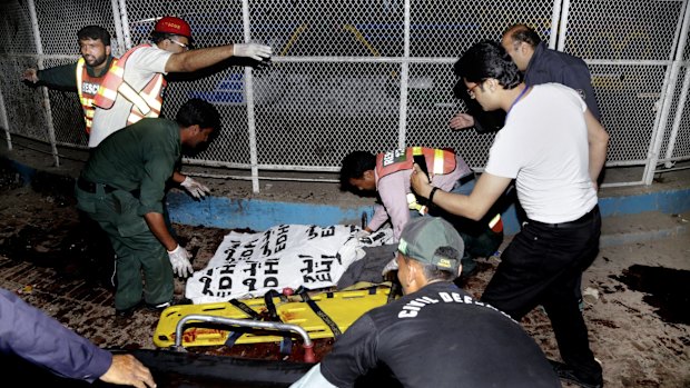 Pakistani rescue workers remove a body from the site of  the Lahore blast on Sunday. 