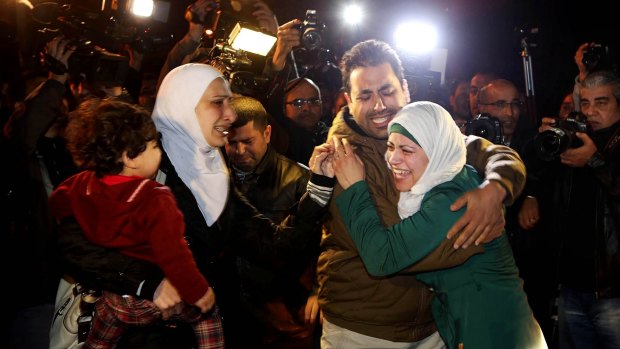 Heartbroken: A man comforts the wife of Jordanian pilot Muath al-Kasasbeh on Wednesday before the video surfaced.