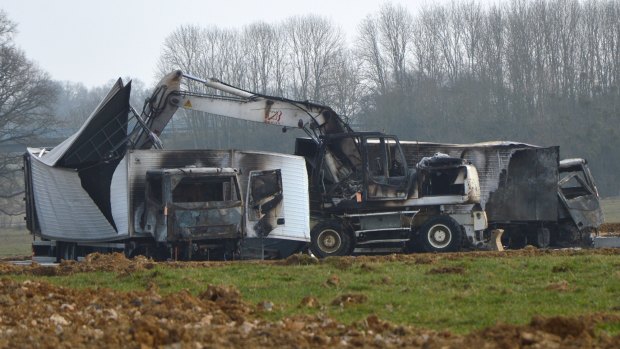 The burnt out vans are seen near the Avallon motorway exit, central France. 