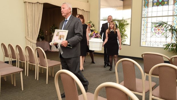 Funeral director Peter Elberg (left) leads the coffin containing the remains of Khandalyce Pearce at Peter Elberg Funerals in Adelaide on Wednesday.