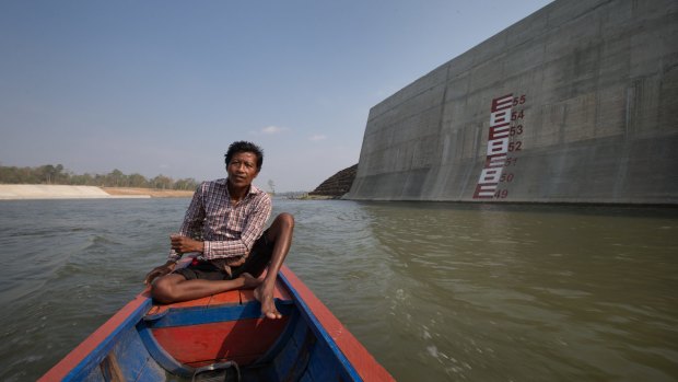 Ota Khami drives his boat where his home used to be.