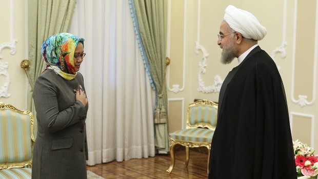 Iranian President Hassan Rouhani, right, greets Indonesian Foreign Minister Retno Marsudi at the start of their meeting in Tehran on Wednesday. 