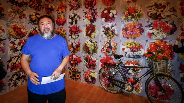 Ai Weiwei in front of one of his new works, With Flowers, 2015, at the National Gallery of Victoria for the Andy Warhol|Ai Weiwei exhibition.