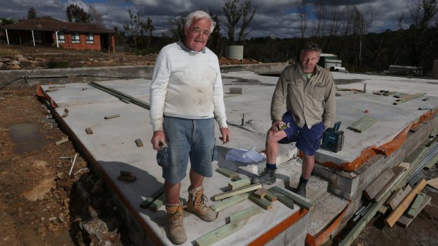 Alan and Craig Seaman work on rebuilding the family home in Buena Vista Road, Winmalee.