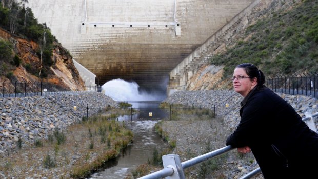Ellen Schwab, digital education and engagement officer at Icon Water, with the Cotter Dam wall behind her.