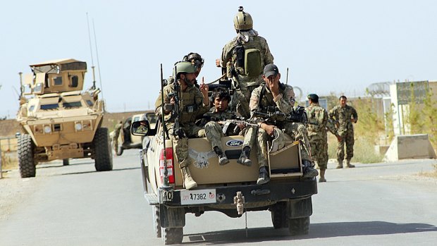 Afghan National Army soldiers arrive to start an operation, outside of Kunduz.