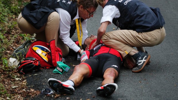 Australia's Richie Porte gets medical assistance after crashing in the descent of the Mont du Chat pass during the ninth stage of the Tour de France cycling race over 181.5 kilometers (112.8 miles) with start in Nantua and finish in Chambery, France.