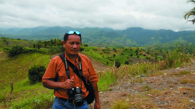 Killing fields: Journalist Aquiles Zonio, who withdrew from the doomed convoy on the morning of the Ampatuan massacre, pictured here at the killing site. 
