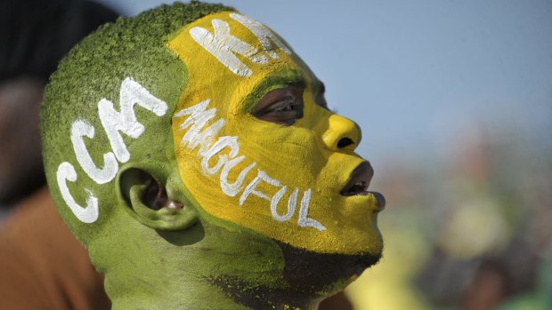 A supporter wears facepaint on which is written the initials of the ruling Chama Cha Mapinduzi (CCM) party, and the surname of their presidential candidate John Magufuli, at an election rally in Dar es Salaam, Tanzania on Friday.