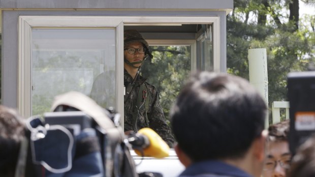 A South Korean army soldier stands guard at a gate of a reserve forces training camp in Seoul, South Korea on Wednesday.