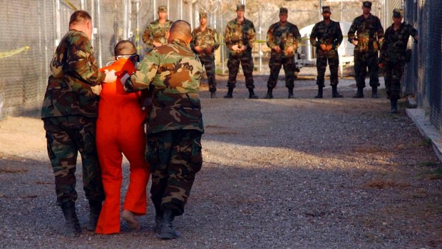 A detainee is escorted to his cell at Guantanamo Bay naval base in Cuba.