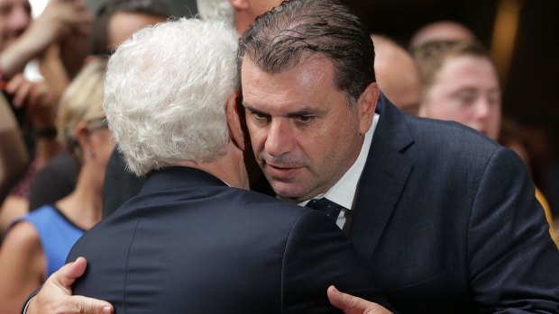 Footbal Federation Australia chairman Frank Lowy and Socceroos coach Ange Postecoglou embrace during celebrations in Sydney on Sunday.