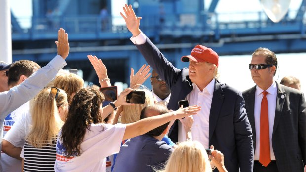 Republican presidential candidate Donald Trump waves as he makes his way to the stage in Florida on Saturday.