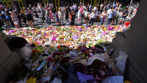 The public view the floral tributes to the victims of January's Bourke Street Mall rampage.