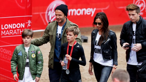 Romeo Beckham (centre) has the support of brother Cruz (left), father David, mother Victoria and older brother Brooklyn after taking part in the junior run at the London Marathon.