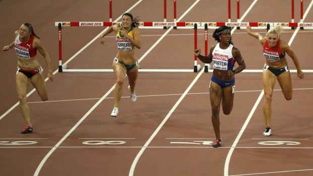 Switzerland's Noemi Zbaeren, Australia's Michelle Jenneke, Britain's Tiffany Porter and Germany's Cindy Roleder cross the line in the women's 100m hurdles semi-final on Friday.