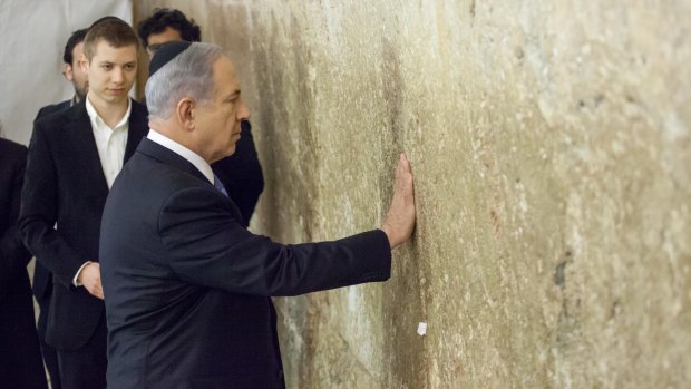 Israeli Prime Minister Benjamin Netanyahu prays at the Western Wall in Jerusalem last year.