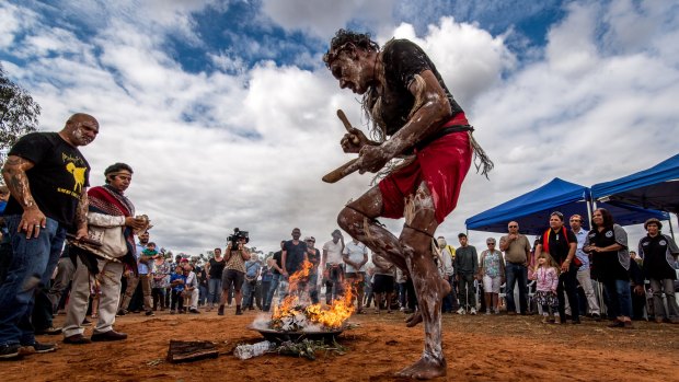 Fire and smoke are the companions of the 105 repatriated ancestors throughout their journey back to country. Mutthi Mutthi elder David Edwards performs a ceremonial dance at Balranald, NSW.