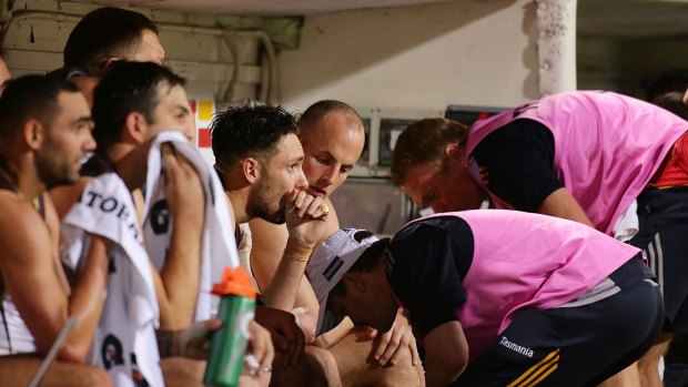 Hawthorn medical staff check on Jack Gunston after he left the field with a leg injury during the semi-final on Friday.