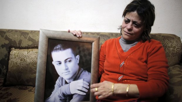 The mother of Muhammad Musallam with her son's photo in February.