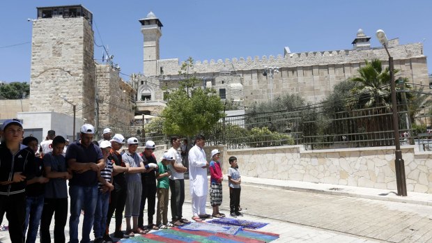 Palestinians attend Friday prayers at the Ibrahimi Mosque during the holy month of Ramadan. 
