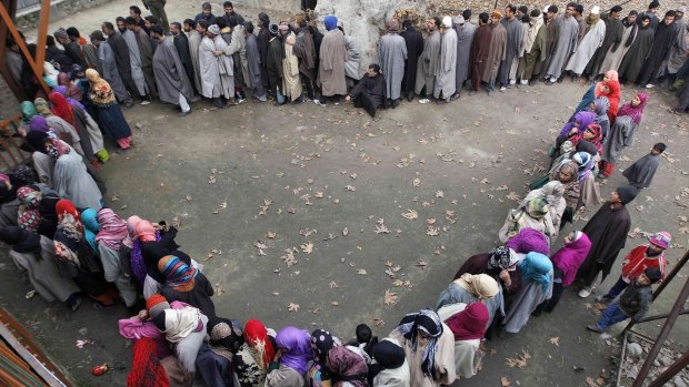 People wait in queues to cast their votes in Srinagar.