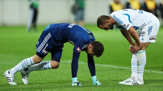 Carl Valeri (right) of the Victory checks on Nathan Coe after the goalkeeper sustained an injury during the match against the Wellington Phoenix on April 5.