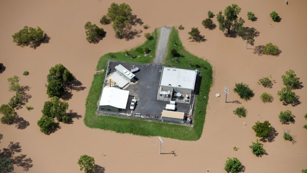 Before the peak: A property is surrounded by floodwaters near Rockhampton.