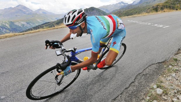Stage winner ... Italian Vincenzo Nibali eats while speeding downhill during the 138-kilometre nineteenth stage.