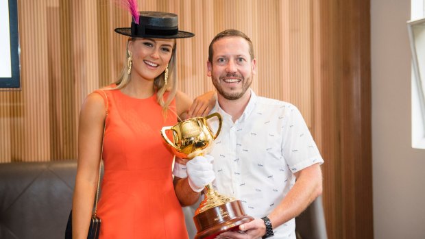 Myer Fashions on the Field ambassador Stephanie Smith and Huxtaburger owner Daniel Wilson with the Melbourne Cup. 