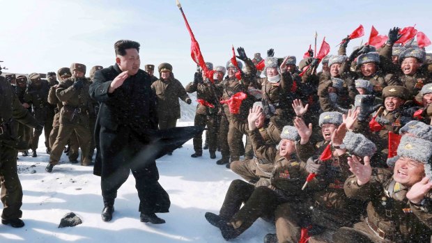 North Korean leader Kim Jong-un greets Korean People's Army pilots during a visit to the summit of Mt Paektu.