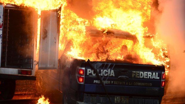 Conflagration: Vehicles burn during the protests in Guerrero.