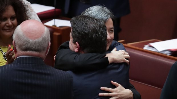 Leader of the Opposition in the Senate Penny Wong embraces Liberal senator Dean Smith after the Marriage Amendment Bill goes through the Senate on Wednesday.