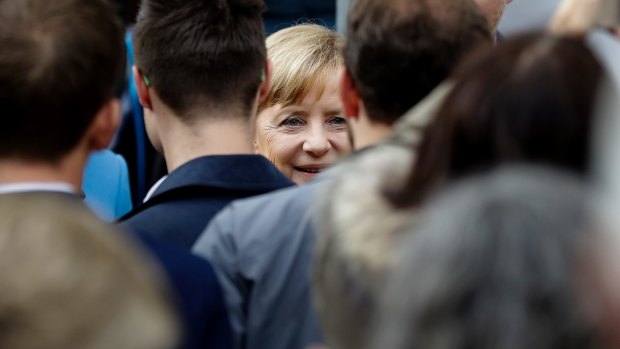 German Chancellor and Chairwoman of the Christian Democratic Union party (CDU), Angela Merkel, centre, arrives for an election campaign rally in Regensburg, Germany, on Monday.