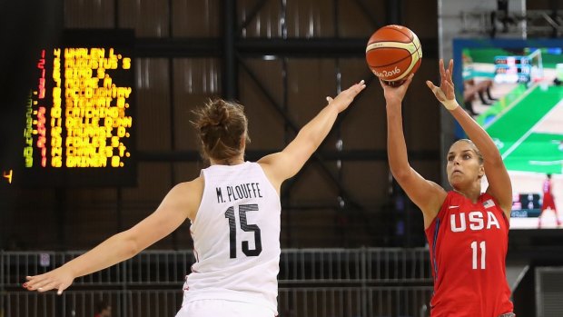 Out and proud: American star Elena Delle Donne puts up a shot over Canada's Michelle Plouffe.
