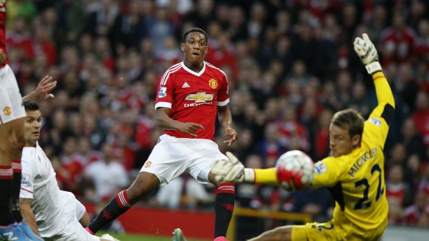 Rivalry renewed: Anthony Martial scores past Simon Mignolet in September.
