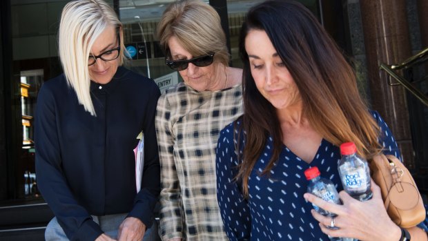 Ray Walker's widow Jennifer Walker, centre, with daughter Kate Herztog, right, leave court on Wednesday. 